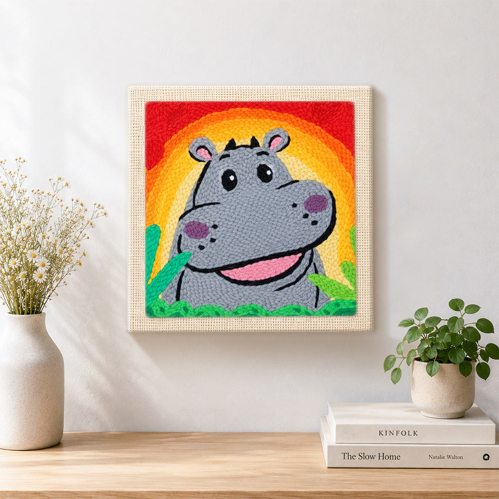 Finished smiling gray hippo with rainbow sunset artwork displayed on a wall