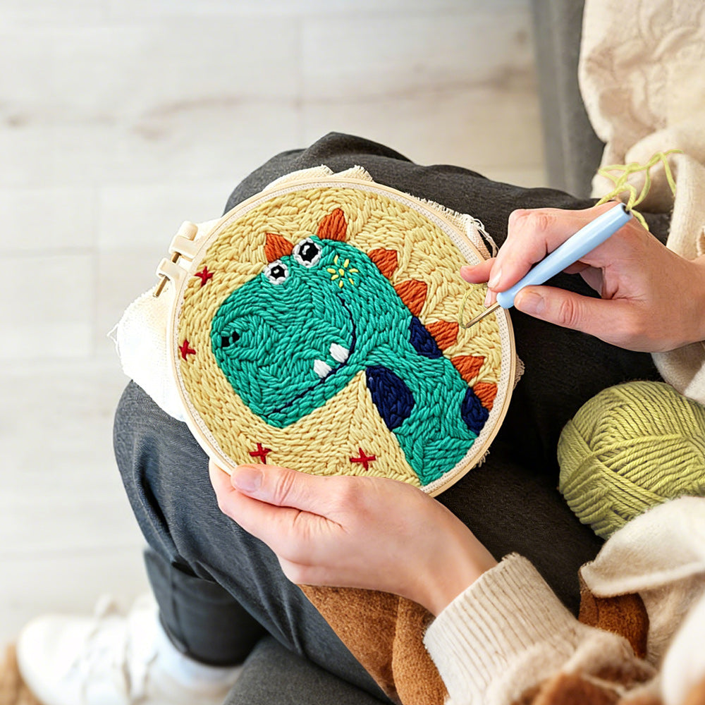 Creating handmade smiling green dinosaur punch needle artwork