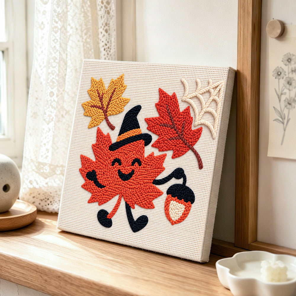 Creating handmade smiling maple leaf with witch hat punch needle artwork