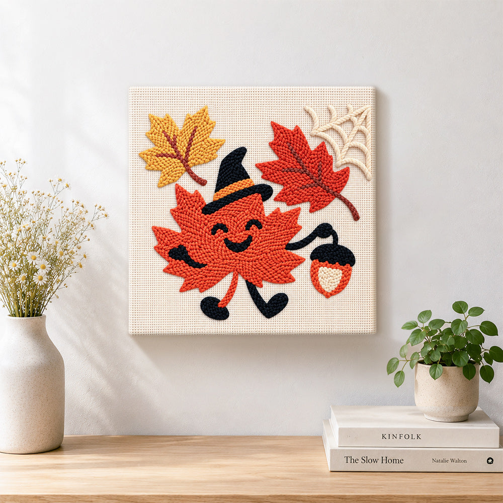 Finished smiling maple leaf with witch hat artwork displayed on a wall