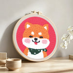 Smiling shiba inu punch needle artwork displayed on a table