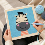 Creating handmade smiling zebra head punch needle artwork