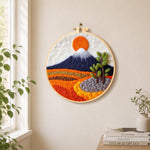 Snow-capped mountain at sunrise needle felt wall art displayed in a bright home interior