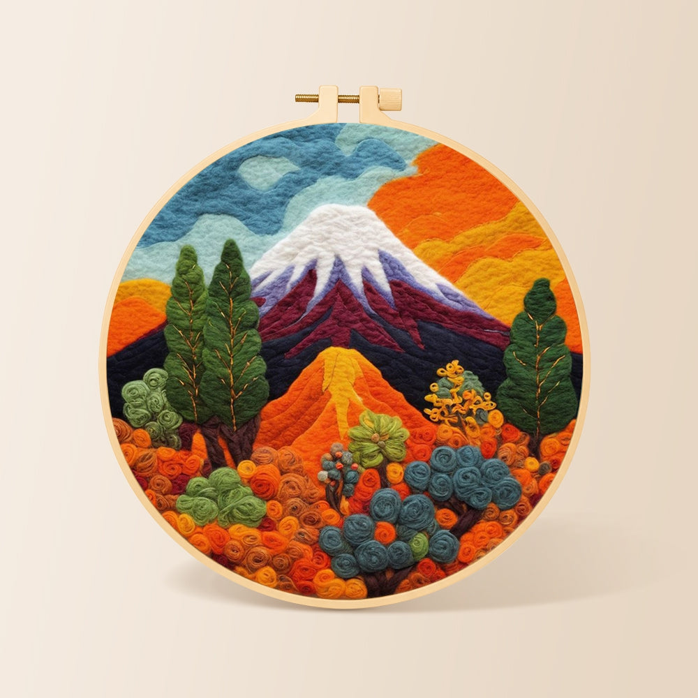 Snow-capped volcano and lush plants needle felting kit for beginners with a round wooden frame