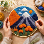 Creating the snow-capped volcano wool painting by hand with a felting needle
