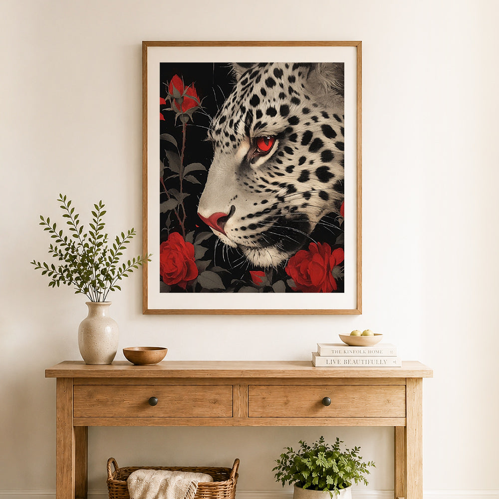Finished snow leopard and red roses cross stitch artwork displayed as home decor