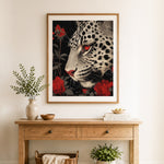 Finished snow leopard and red roses cross stitch artwork displayed as home decor