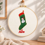 Snowman christmas stocking embroidery hoop wall art displayed as warm and cozy handmade home decor