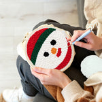 Creating handmade snowman face unch needle artwork