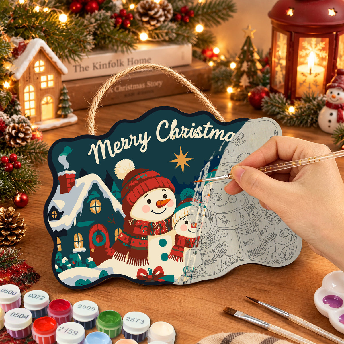 Snowman family with cozy cottage paint by numbers door hanger painting process