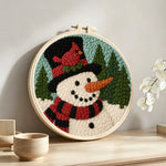Snowman with red cardinal bird punch needle artwork displayed on a table
