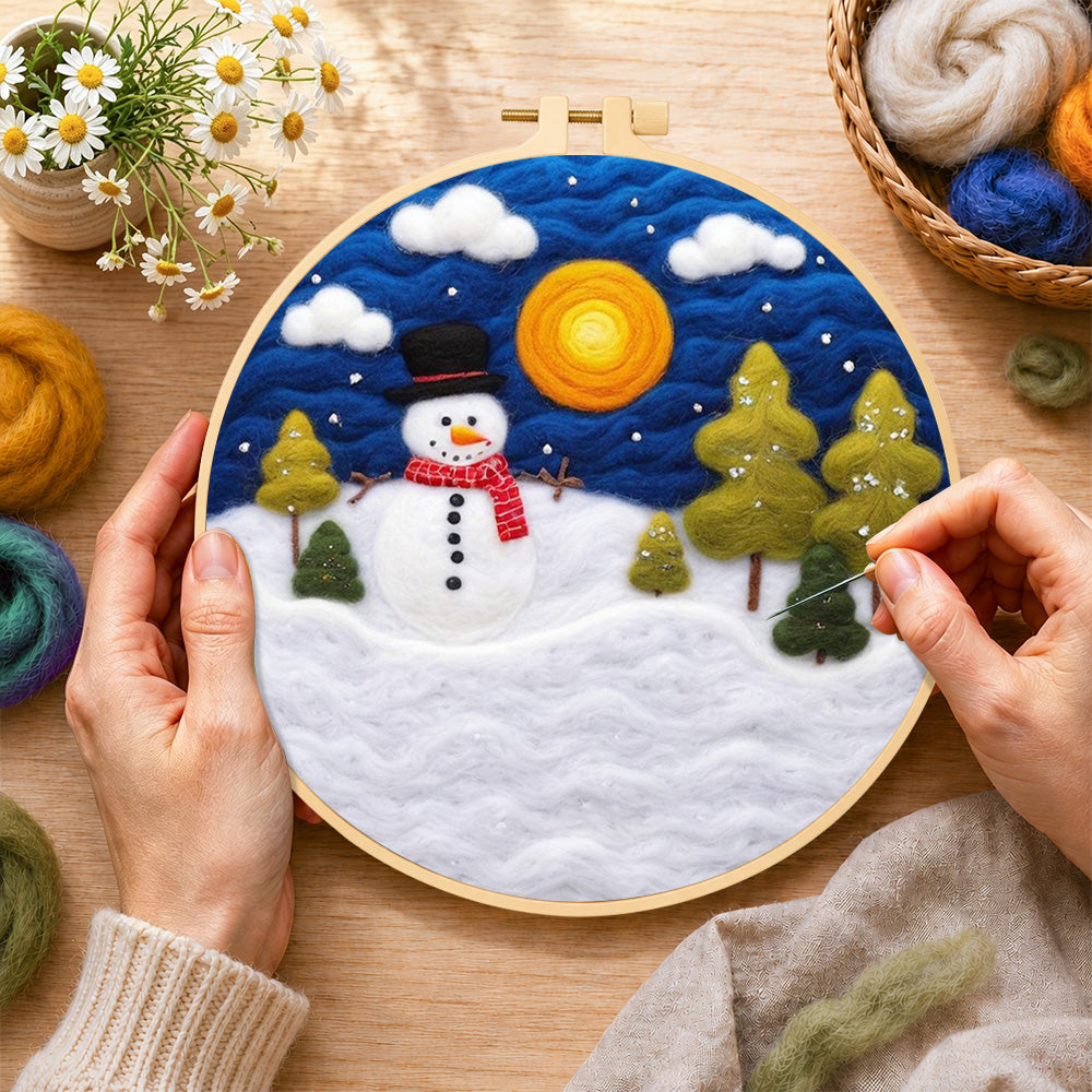 Creating the snowman with red scarf and pine trees wool painting by hand with a felting needle