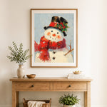 Finished snowman with top hat and red scarf cross stitch artwork displayed as home decor
