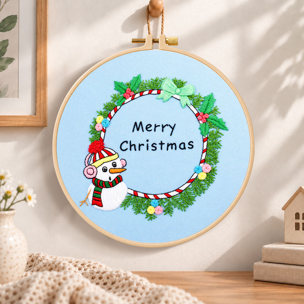 Snowman wreath quote embroidery hoop wall art displayed as warm and cozy handmade home decor