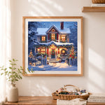 Finished snowy christmas house with glowing lights cross stitch artwork displayed as home decor