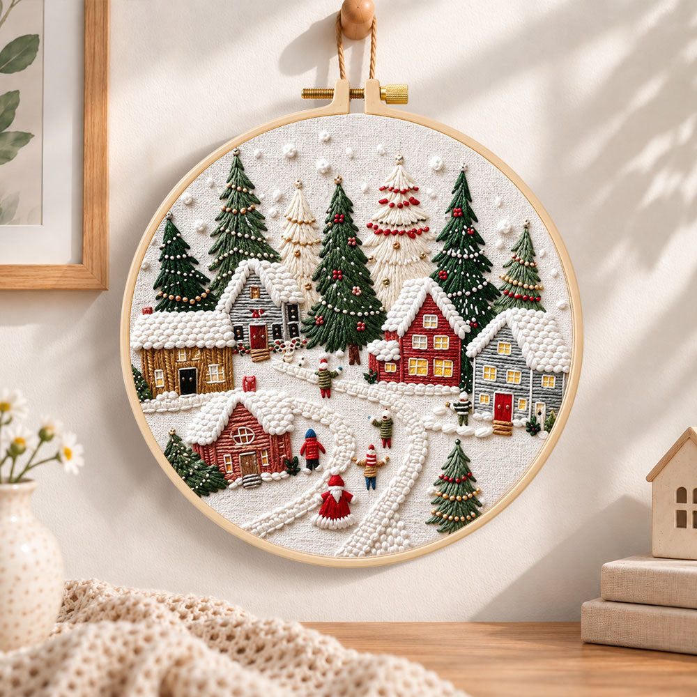 Snowy christmas village embroidery hoop wall art displayed as warm and cozy handmade home decor