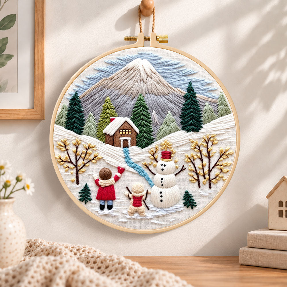 Snowy mountain holiday fun embroidery hoop wall art displayed as warm and cozy handmade home decor
