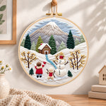 Snowy mountain holiday fun embroidery hoop wall art displayed as warm and cozy handmade home decor
