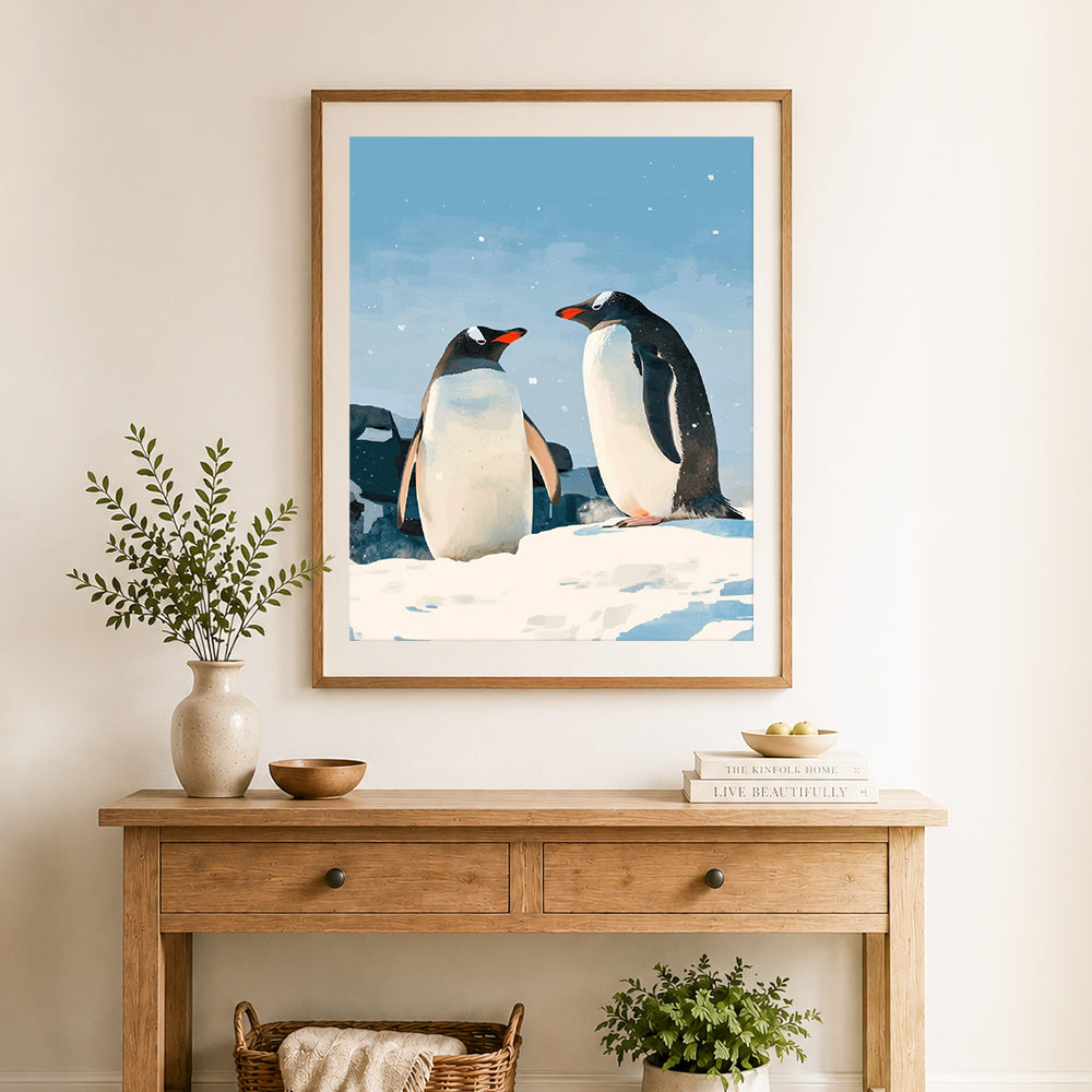 Finished snowy penguin pair cross stitch artwork displayed as home decor