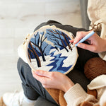 Creating handmade snowy river landscape with bare trees punch needle artwork
