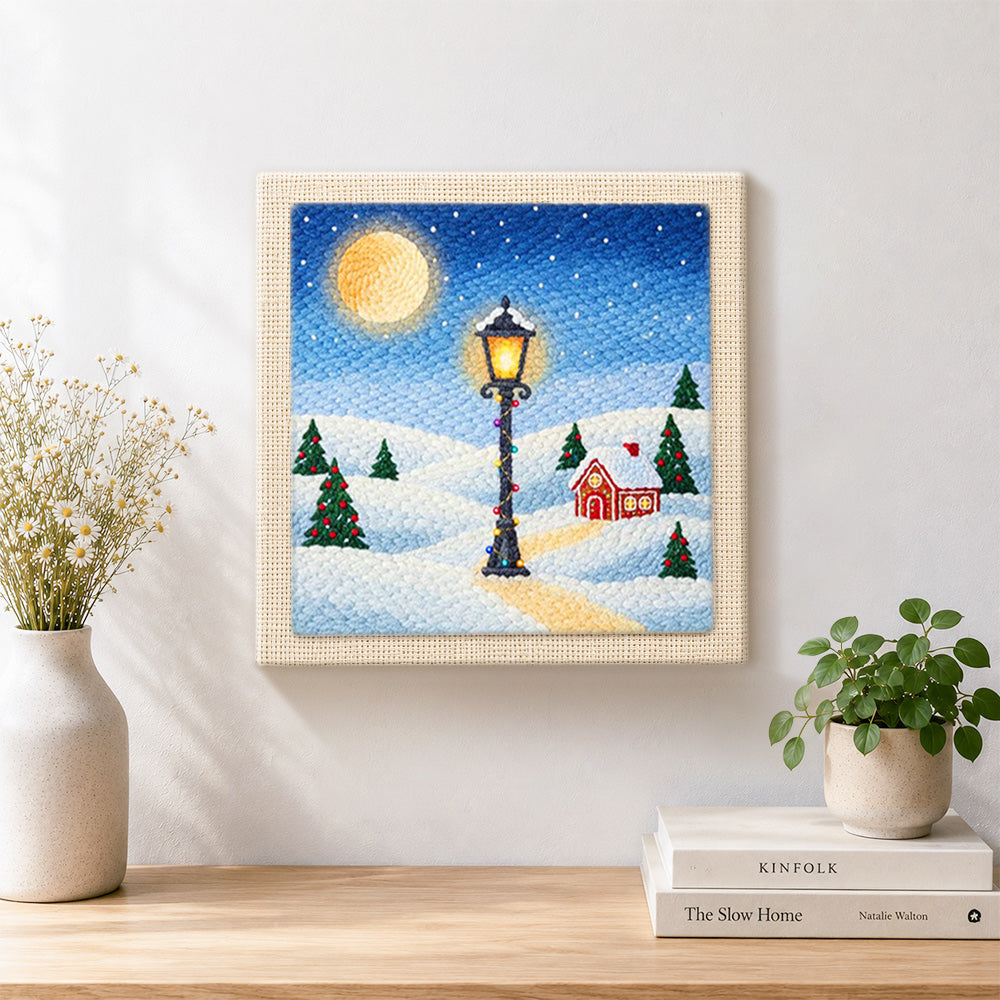 Finished snowy street lamp scene artwork displayed on a wall
