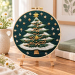 Snowy striped christmas tree embroidery kit finished hoop displayed on a wooden stand as cozy tabletop decor