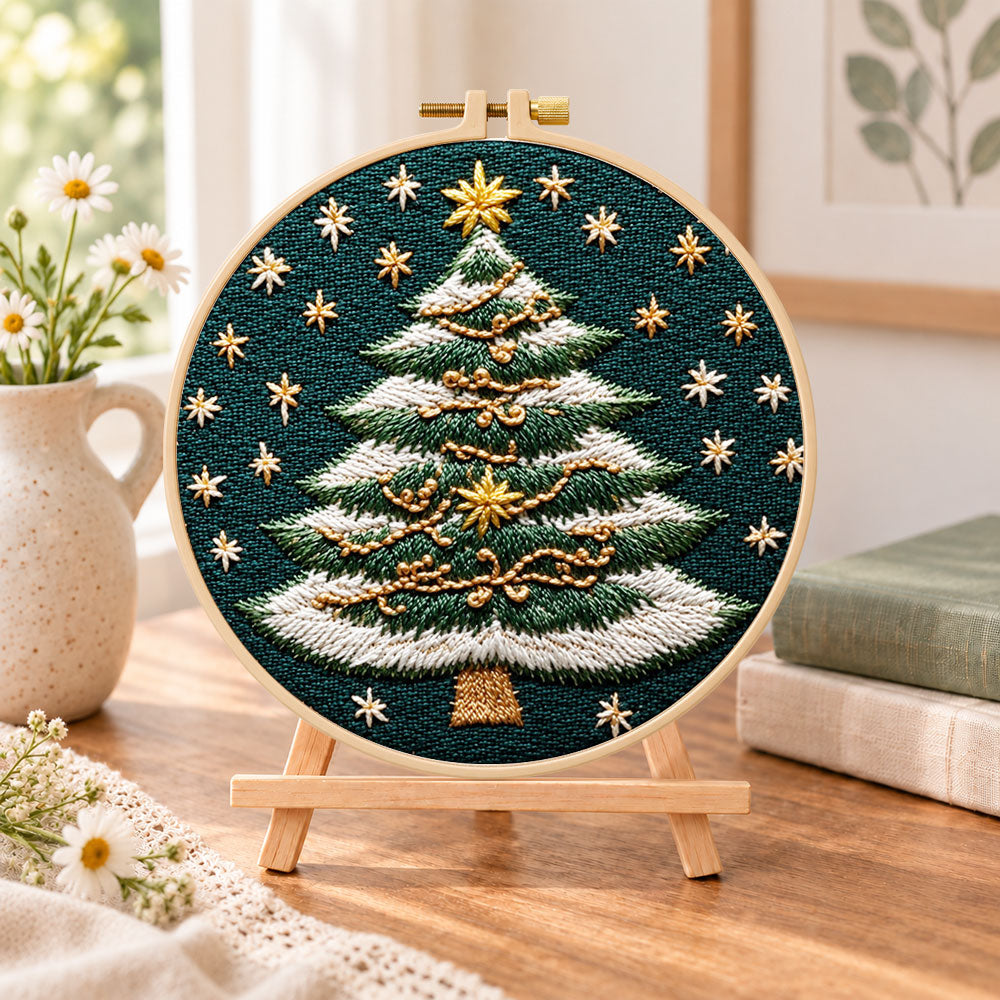 Snowy striped christmas tree embroidery kit finished hoop displayed on a wooden stand as cozy tabletop decor