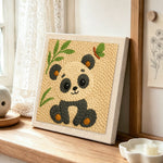 Soft bamboo panda punch needle artwork displayed on a table