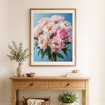 Finished soft blush peonies cross stitch artwork displayed as home decor
