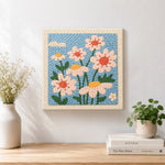 Finished soft daisies artwork displayed on a wall