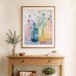 Finished soft pastel glass bottle art cross stitch artwork displayed as home decor