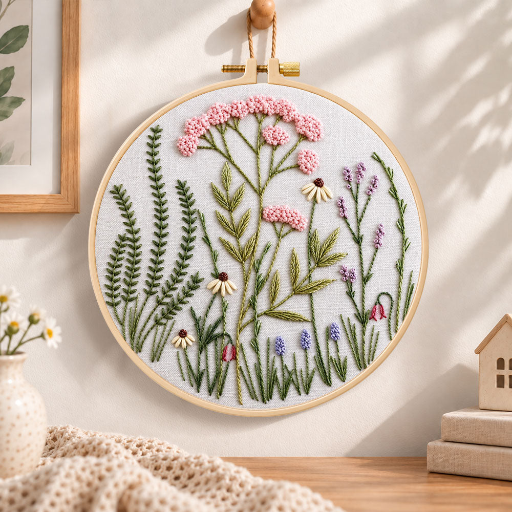 Soft pastel meadow embroidery hoop wall art displayed as warm and cozy handmade home decor