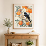 Finished songbird on persimmon branch cross stitch artwork displayed as home decor