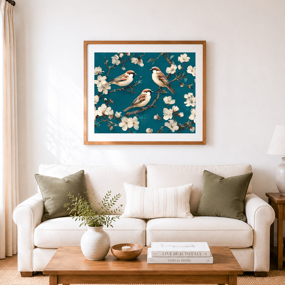 Finished sparrows on spring blossoms cross stitch artwork displayed as home decor