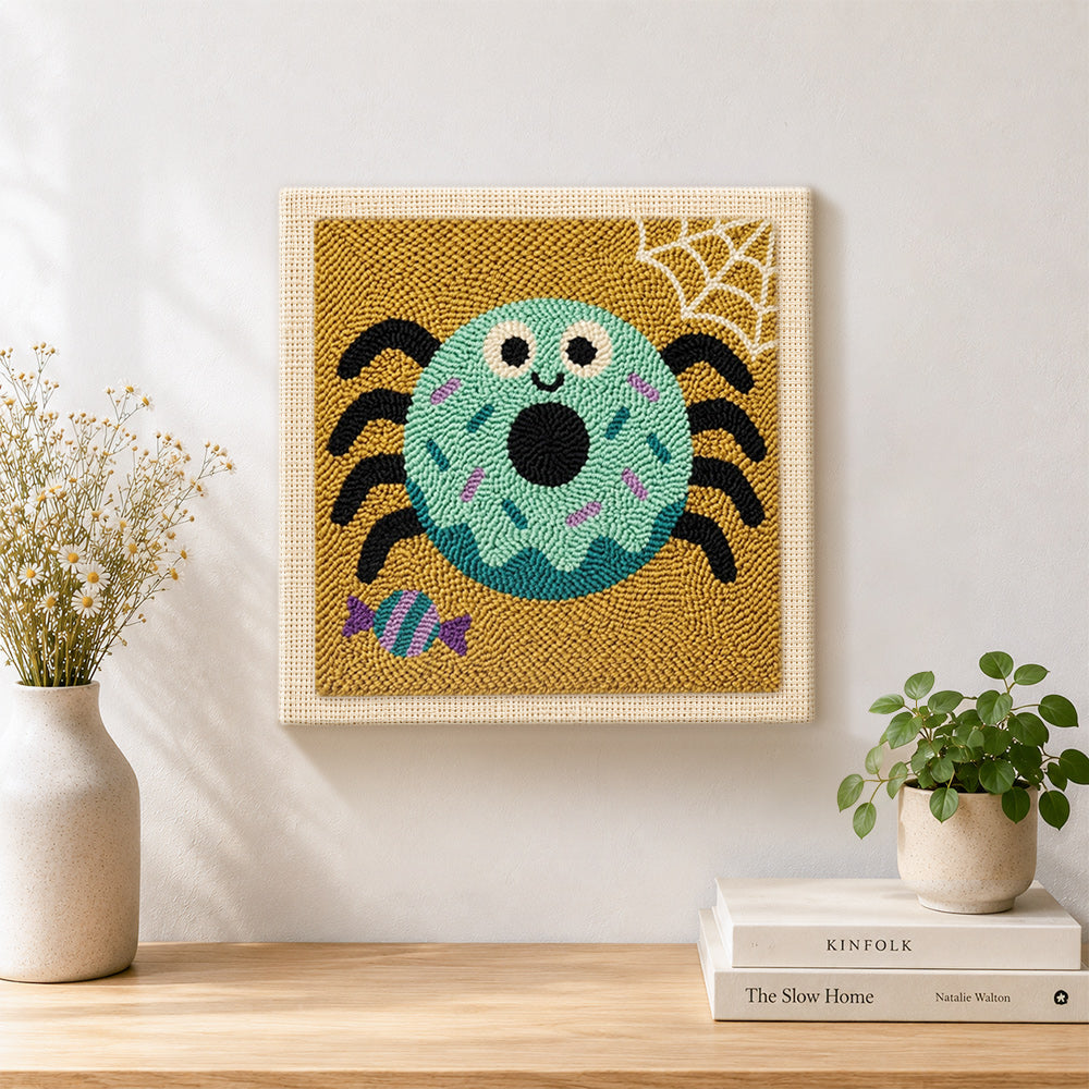 Finished spider donut artwork displayed on a wall