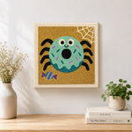 Finished spider donut artwork displayed on a wall