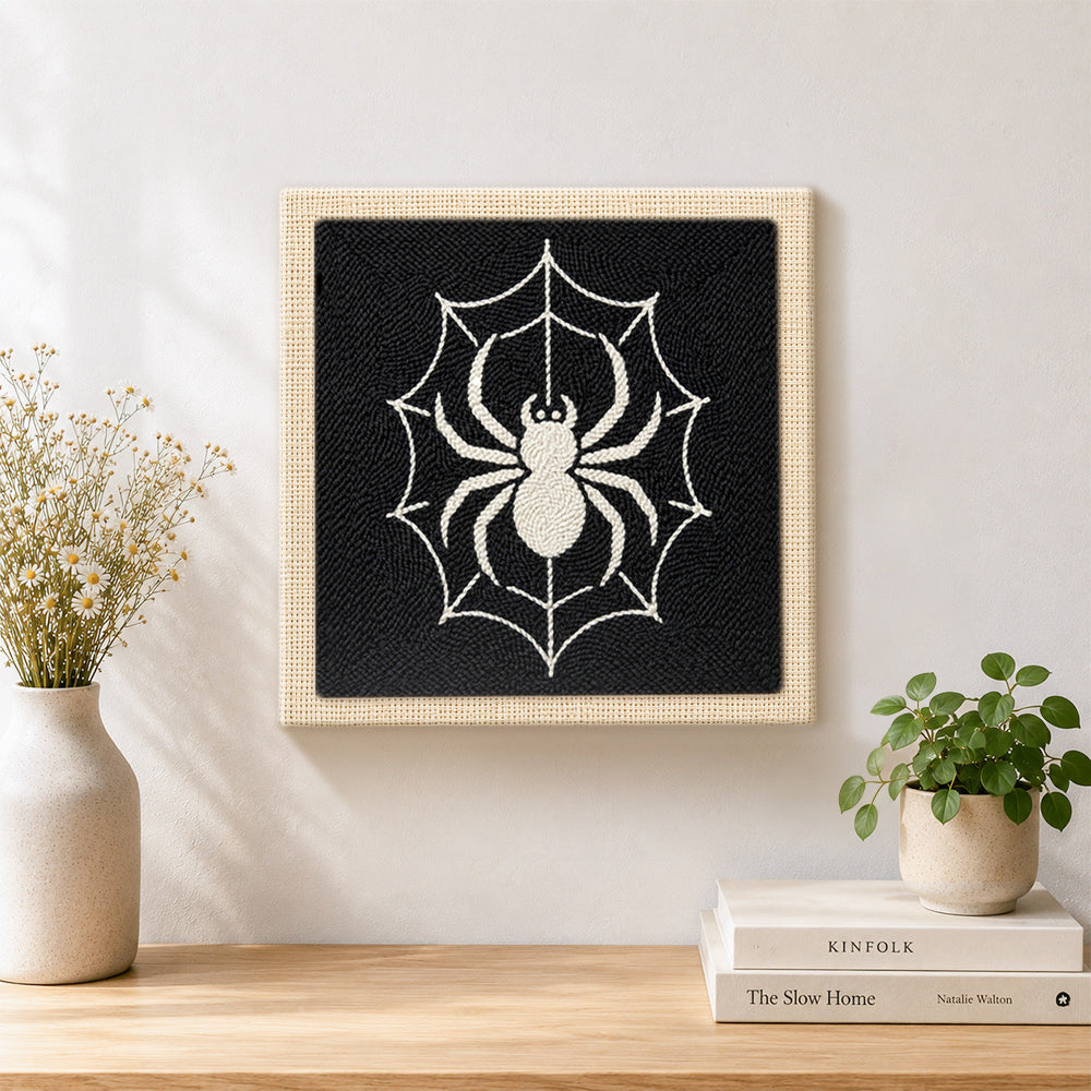 Finished spider on web artwork displayed on a wall