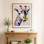 Finished splash‑art giraffe face cross stitch artwork displayed as home decor