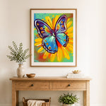 Finished splash paint butterfly cross stitch artwork displayed as home decor