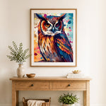 Finished splash‑paint colorful owl cross stitch artwork displayed as home decor