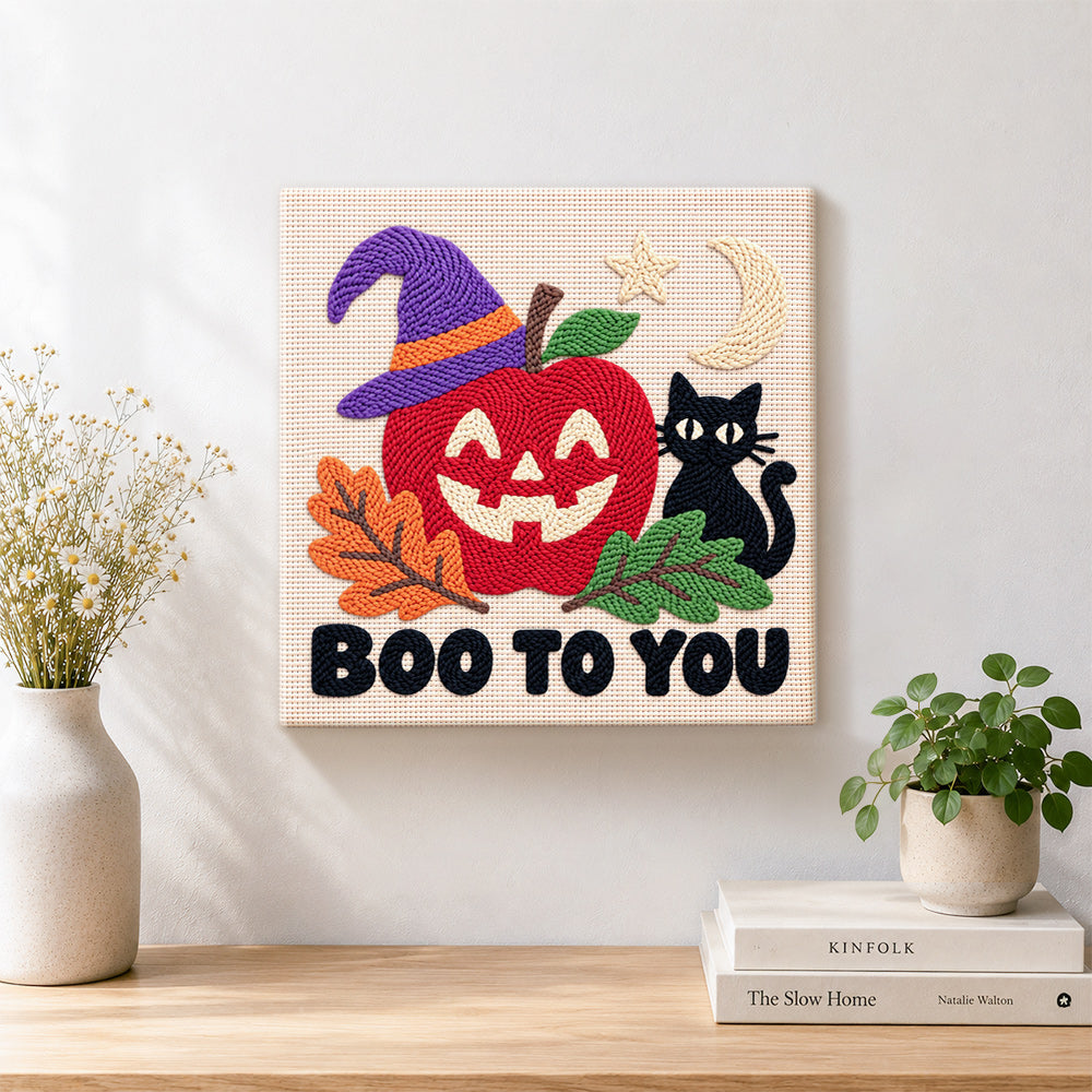 Finished spooky apple face artwork displayed on a wall