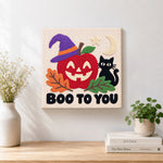 Finished spooky apple face artwork displayed on a wall