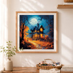 Finished spooky autumn haunted house cross stitch artwork displayed as home decor
