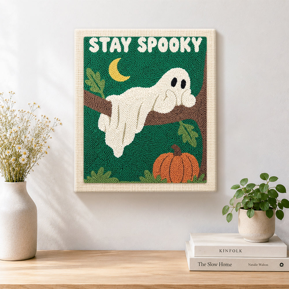Finished spooky ghost on tree branch artwork displayed on a wall
