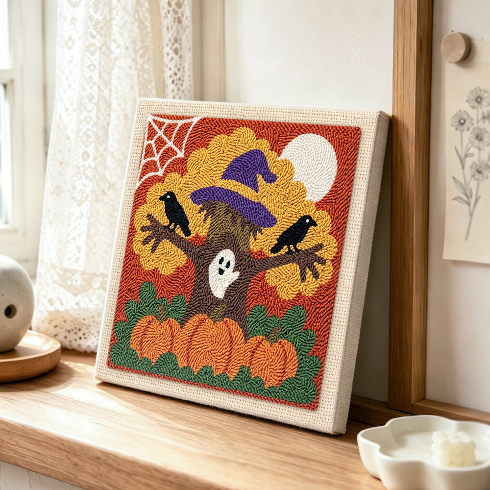 Spooky halloween tree punch needle artwork displayed on a table
