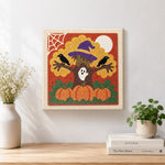 Finished spooky halloween tree artwork displayed on a wall