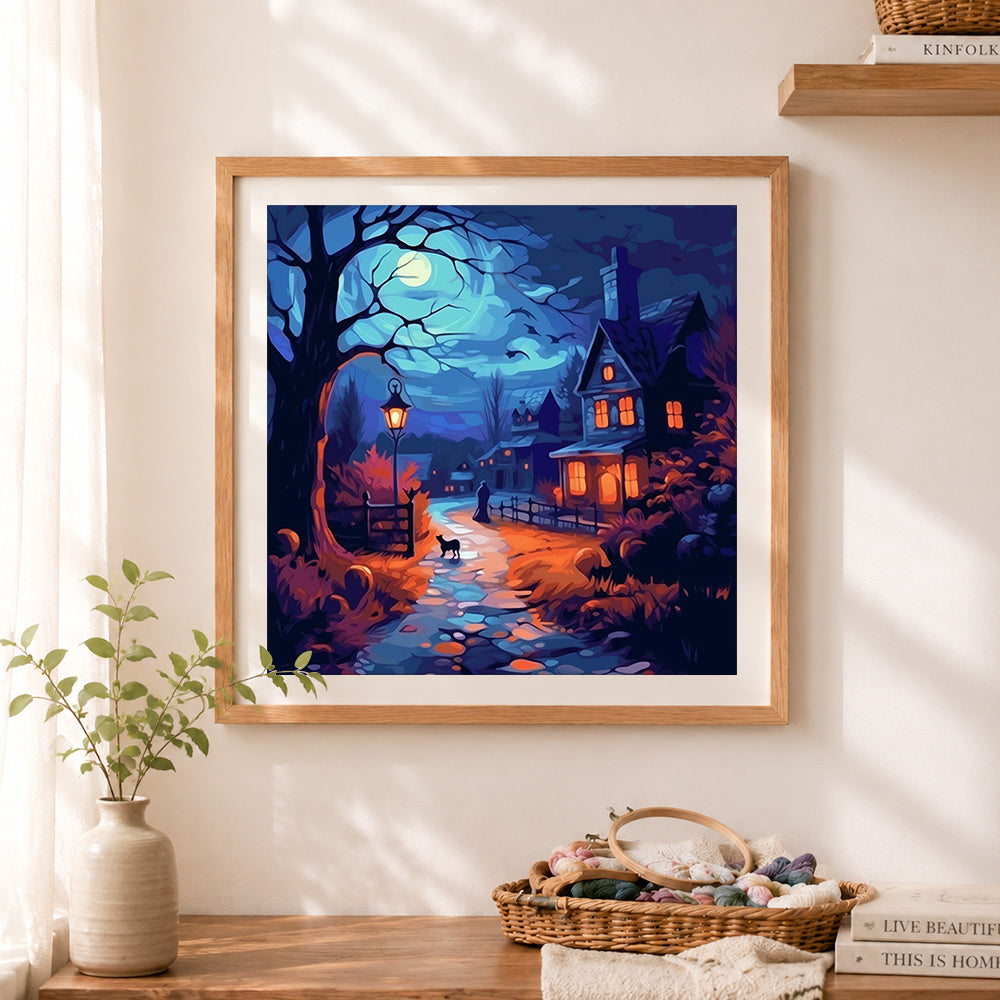 Finished spooky halloween village cross stitch artwork displayed as home decor