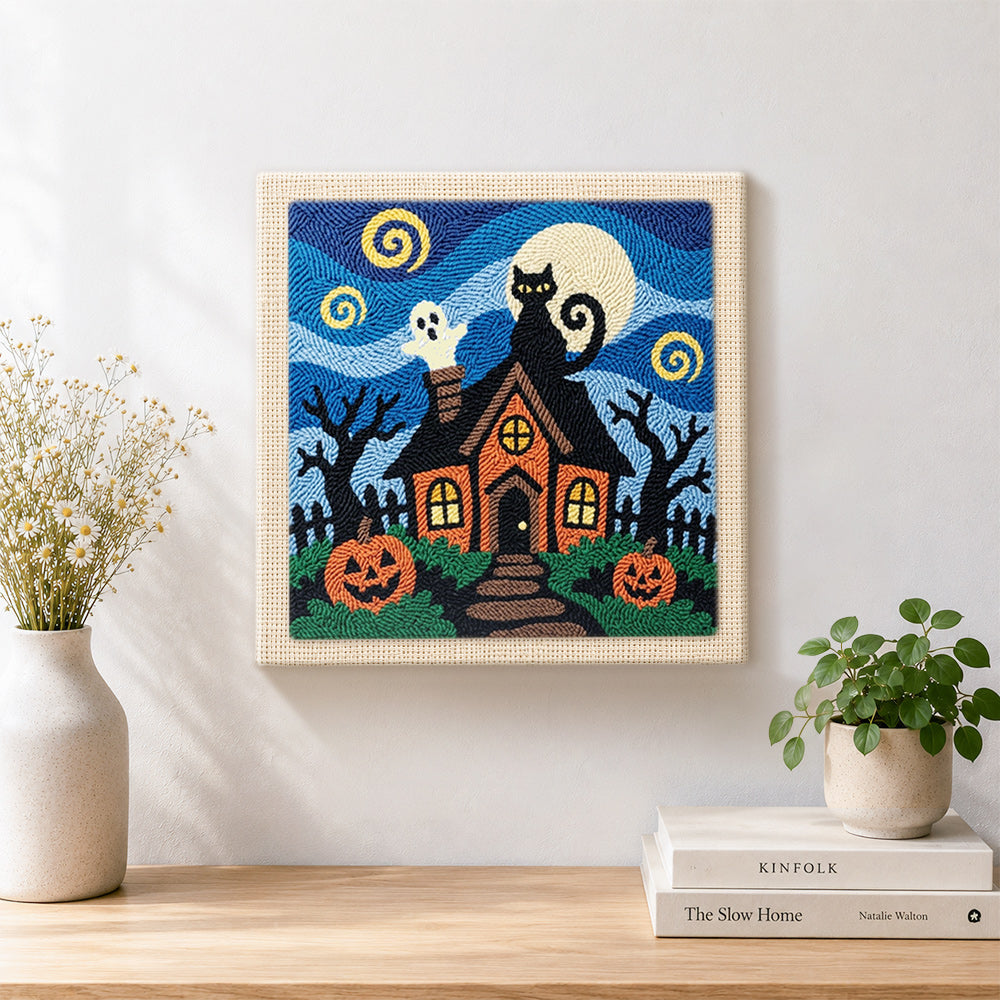 Finished spooky haunted house artwork displayed on a wall