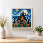 Finished spooky haunted house artwork displayed on a wall