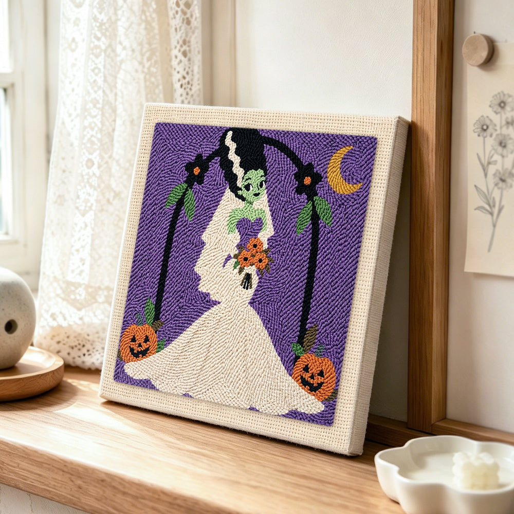 Spooky monster bride punch needle artwork displayed on a table